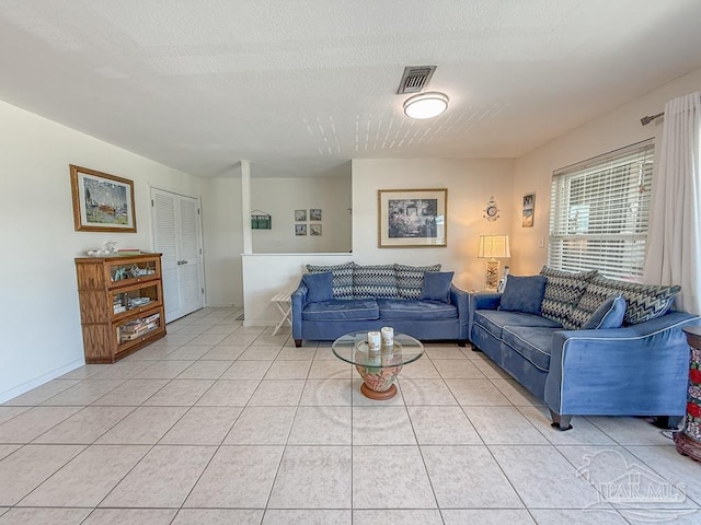 1448 Tina Dr Unit 213, Navarre Beach, FL 32566 - living area with light tile patterned floors and a textured ceiling