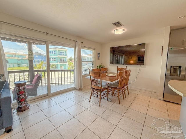 1448 Tina Dr Unit 213, Navarre Beach, FL 32566 - dining area featuring light tile patterned floors and baseboards