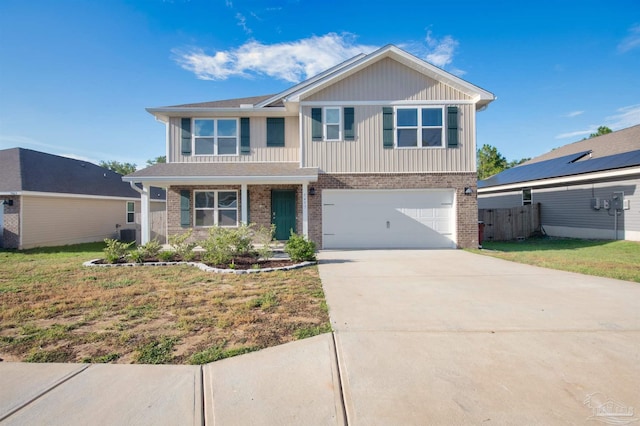5457 Merlin Way, Milton, FL 32583 - view of front of home with brick siding, a garage, concrete driveway, and board and batten siding