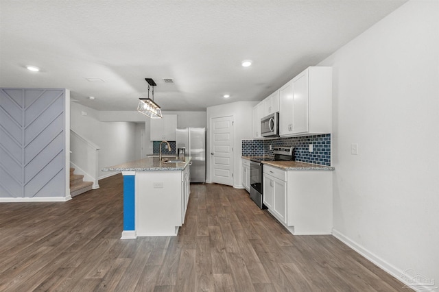5457 Merlin Way, Milton, FL 32583 - kitchen with appliances with stainless steel finishes, dark wood finished floors, white cabinets, baseboards, and recessed lighting