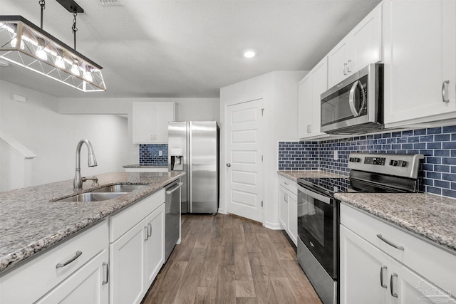 5457 Merlin Way, Milton, FL 32583 - kitchen featuring stainless steel appliances, a sink, dark wood-style floors, and tasteful backsplash