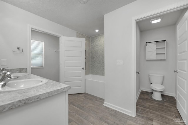 5457 Merlin Way, Milton, FL 32583 - bathroom featuring double vanity, toilet, wood finished floors, shower / washtub combination, and a textured ceiling