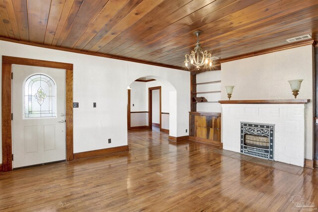 unfurnished living room featuring visible vents, arched walkways, wood ceiling, wood finished floors, and crown molding