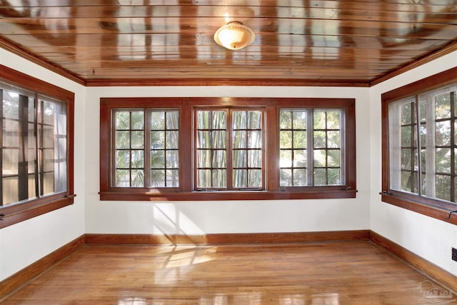 unfurnished sunroom with wood ceiling