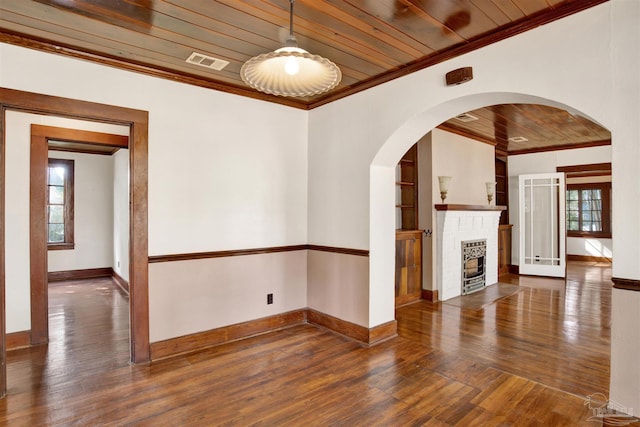 unfurnished living room with a wealth of natural light, wood ceiling, visible vents, and crown molding