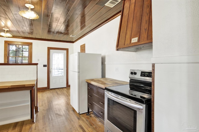 kitchen featuring electric range, visible vents, butcher block countertops, freestanding refrigerator, and light wood-type flooring