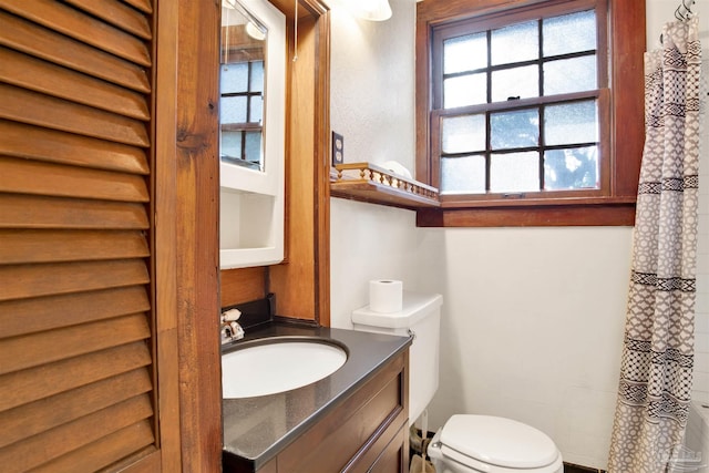 bathroom with vanity, toilet, and a shower with curtain