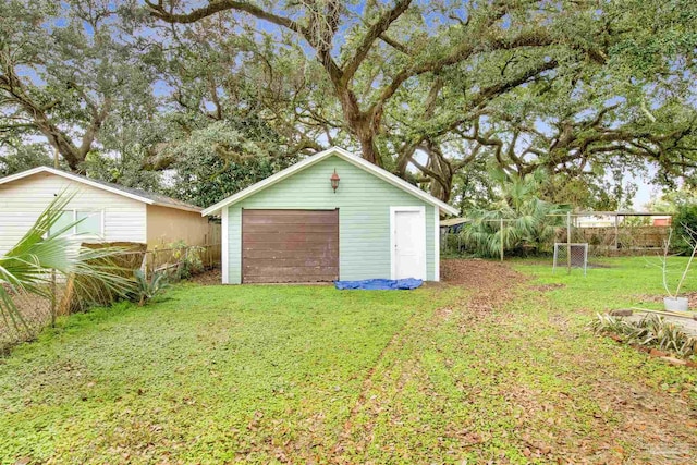 detached garage featuring fence