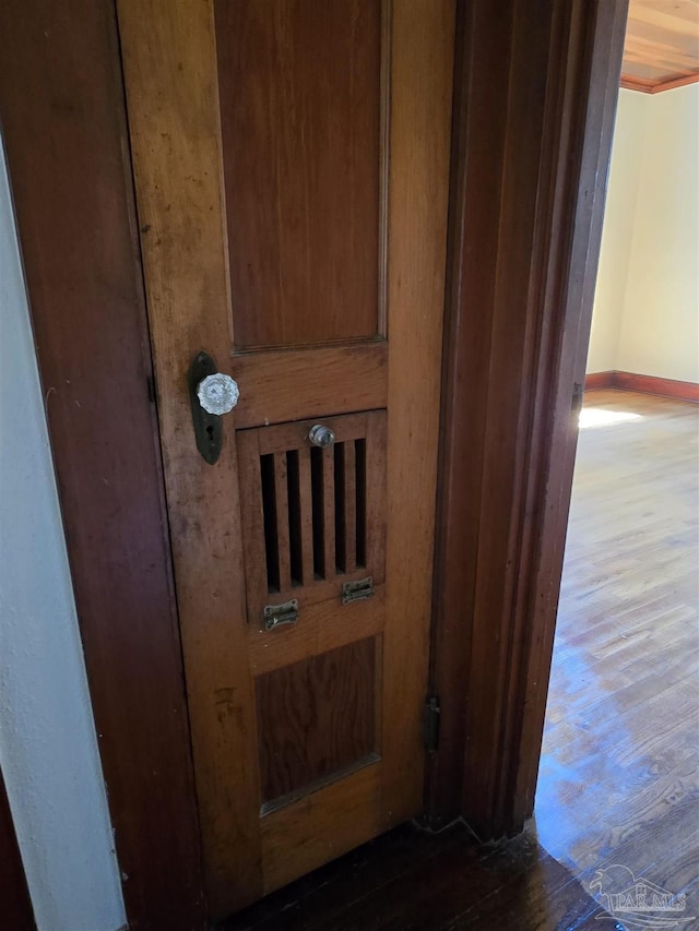 room details featuring baseboards and wood finished floors