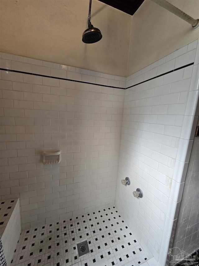 full bath with a tile shower