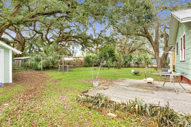 view of yard with fence and a wooden deck