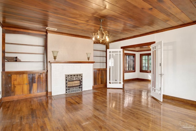 unfurnished living room with wood ceiling, baseboards, crown molding, and wood finished floors