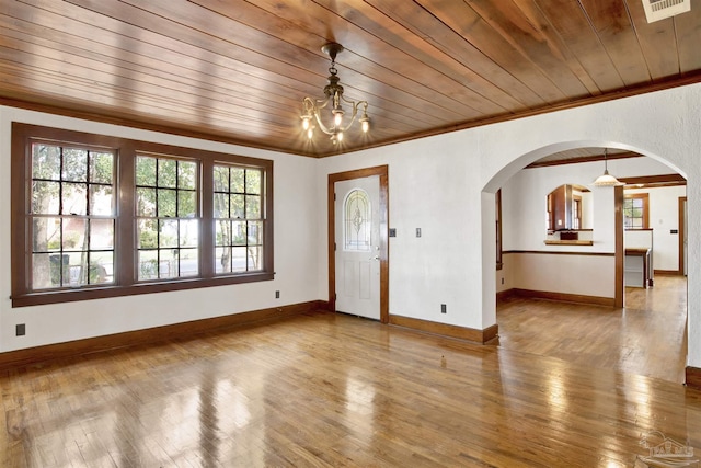 foyer entrance with ornamental molding, wooden ceiling, baseboards, and hardwood / wood-style floors