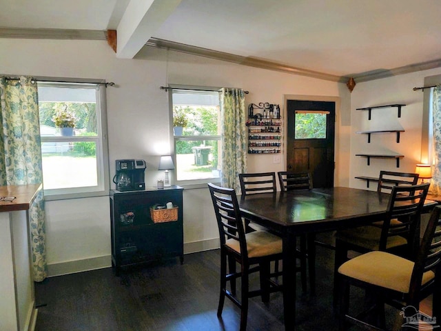 dining room with beam ceiling and dark hardwood / wood-style flooring