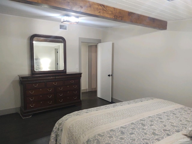 bedroom featuring beam ceiling and dark hardwood / wood-style floors