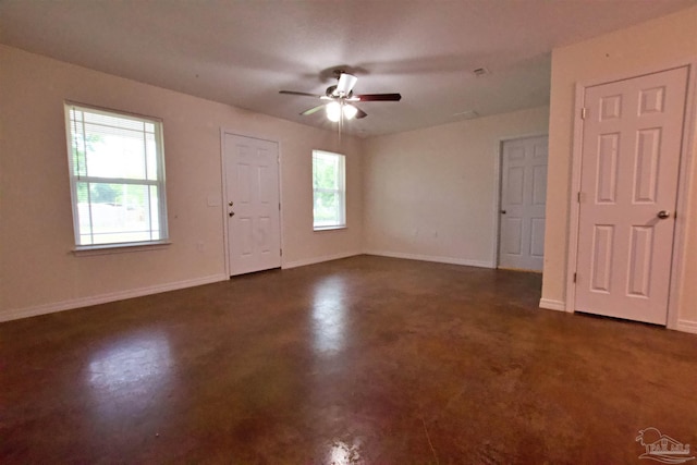 4217 Celtic Cir, Pace, FL 32571 - unfurnished room with ceiling fan, baseboards, and concrete floors