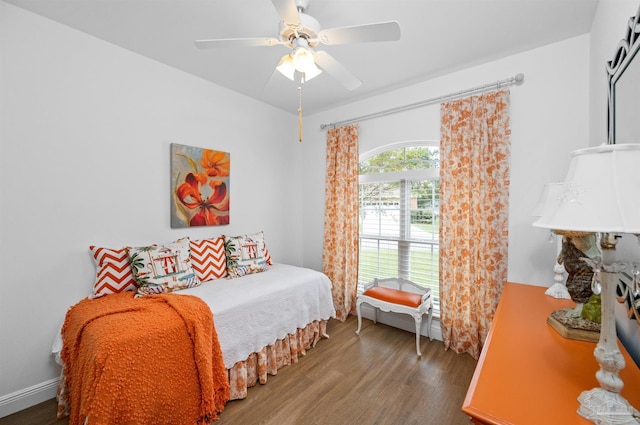 bedroom with ceiling fan and dark hardwood / wood-style flooring