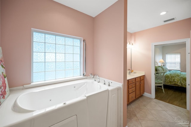 bathroom with vanity, tile patterned flooring, and a washtub