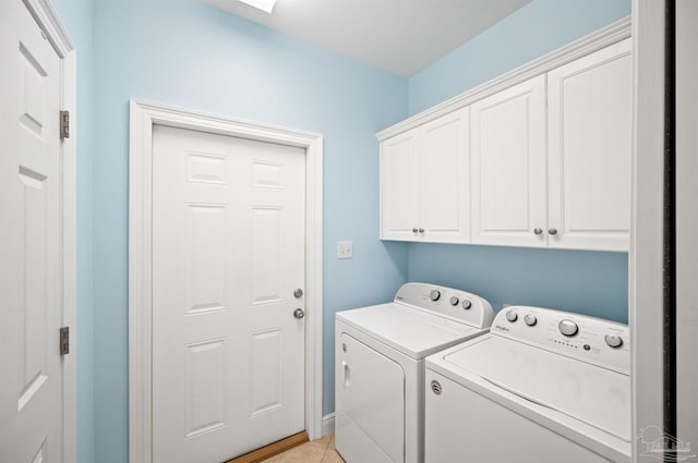 laundry room featuring independent washer and dryer, light tile patterned floors, and cabinets