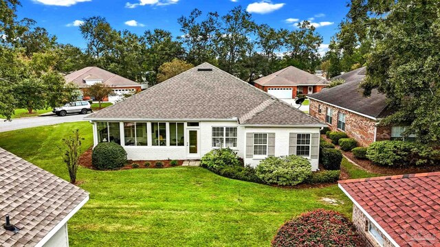 view of front of property with a front lawn and a sunroom