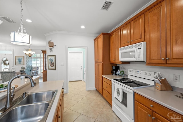 kitchen featuring hanging light fixtures, sink, white appliances, an inviting chandelier, and crown molding