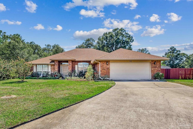 ranch-style home featuring a garage and a front yard