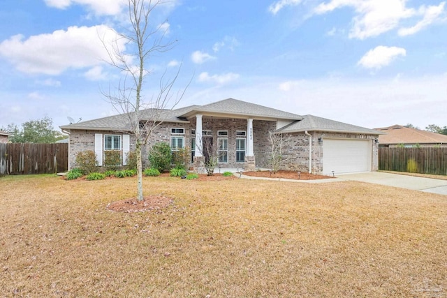 view of front of property with a front yard and a garage