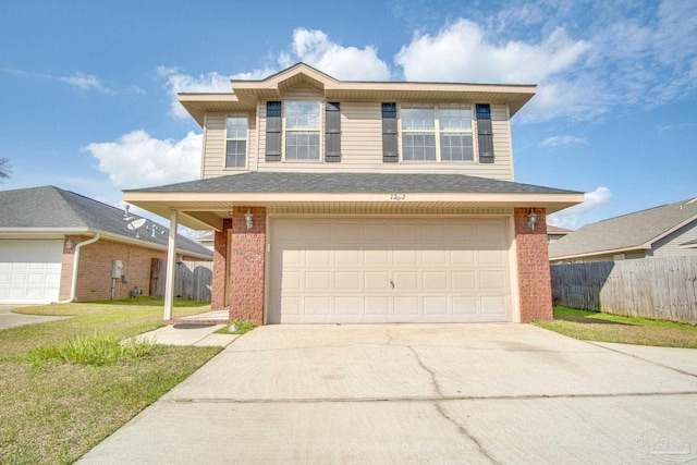 traditional-style house featuring a garage, brick siding, concrete driveway, and fence