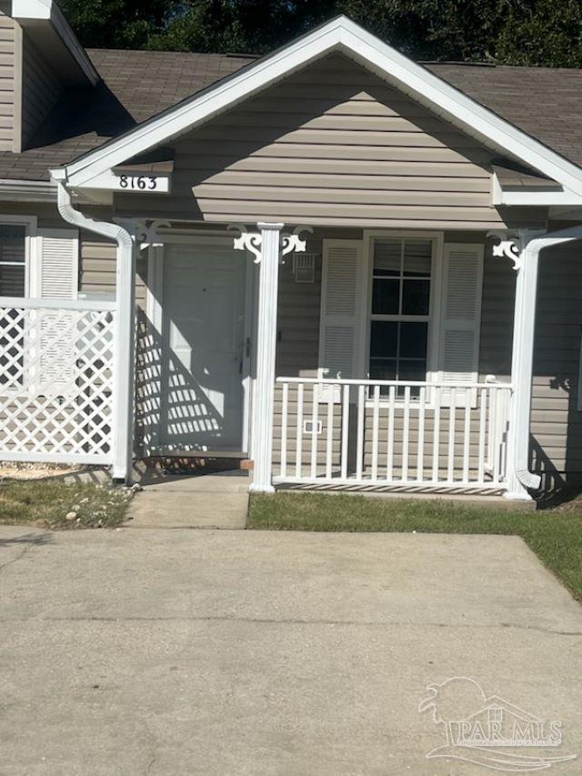 view of exterior entry with a porch