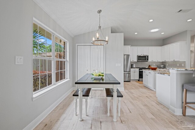 1008 Black Walnut Trl, Pensacola, FL 32514 - kitchen with appliances with stainless steel finishes, white cabinetry, a chandelier, light wood finished floors, and recessed lighting