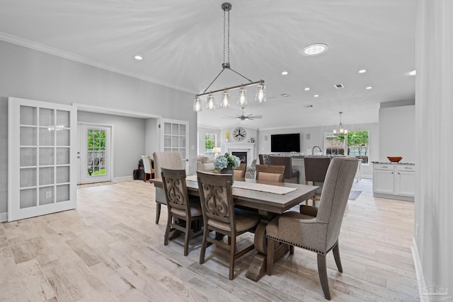 1008 Black Walnut Trl, Pensacola, FL 32514 - dining area with a fireplace, ornamental molding, a chandelier, recessed lighting, and light wood-style flooring