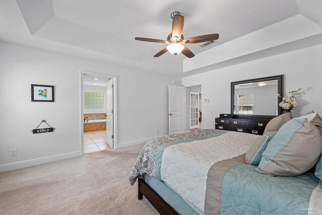 1008 Black Walnut Trl, Pensacola, FL 32514 - bedroom with light colored carpet, baseboards, ensuite bath, ceiling fan, and a tray ceiling