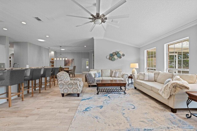 1008 Black Walnut Trl, Pensacola, FL 32514 - living room with light wood finished floors, a textured ceiling, a ceiling fan, crown molding, and vaulted ceiling