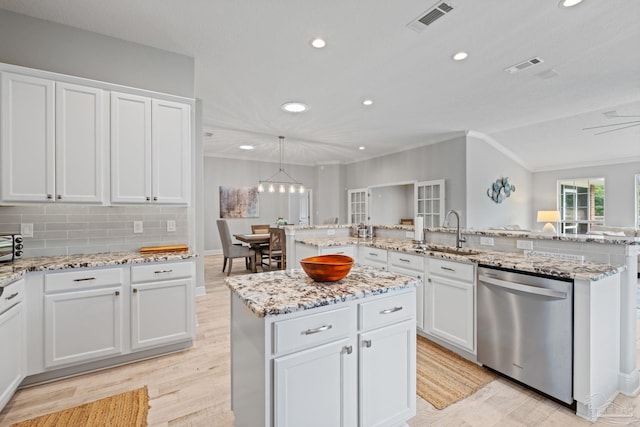 1008 Black Walnut Trl, Pensacola, FL 32514 - kitchen featuring stainless steel dishwasher, a sink, a center island with sink, recessed lighting, and white cabinets