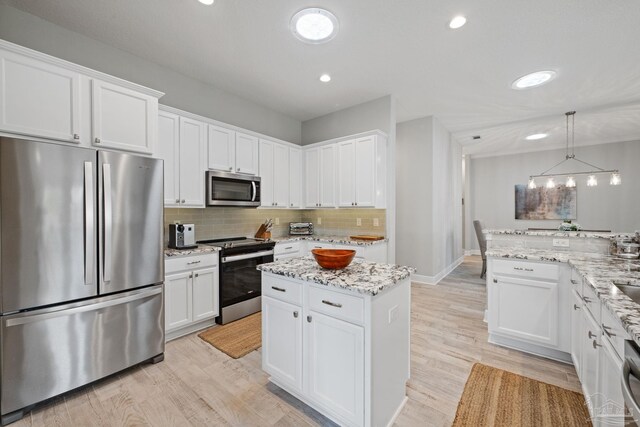1008 Black Walnut Trl, Pensacola, FL 32514 - kitchen featuring stainless steel appliances, light wood-style floors, white cabinetry, decorative backsplash, and recessed lighting