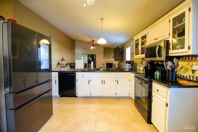 kitchen with sink, black appliances, light tile patterned floors, ceiling fan, and white cabinets