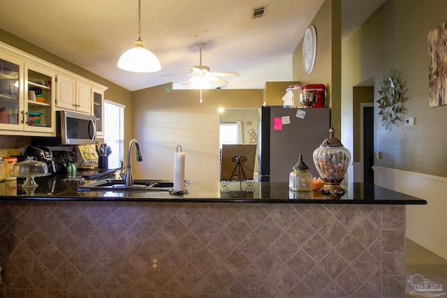 kitchen featuring hanging light fixtures, sink, kitchen peninsula, and appliances with stainless steel finishes