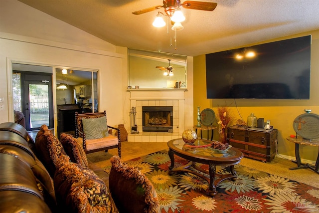 carpeted living room with lofted ceiling, a textured ceiling, a fireplace, and ceiling fan