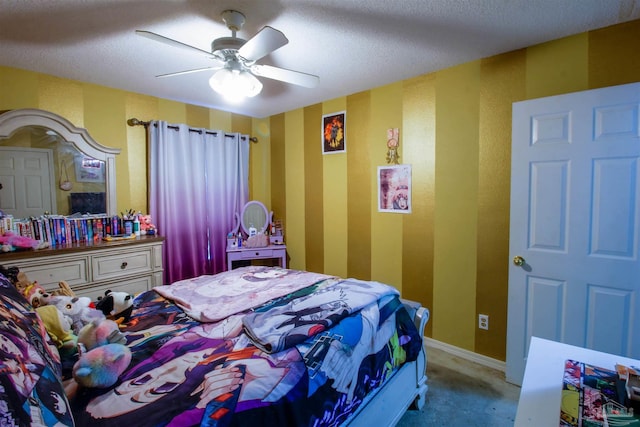 carpeted bedroom featuring ceiling fan and a textured ceiling