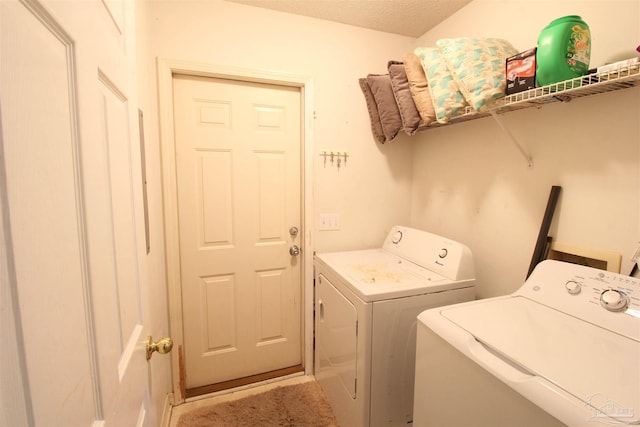 washroom with washing machine and clothes dryer