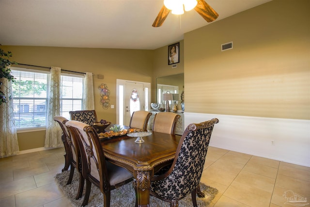 dining space with lofted ceiling, light tile patterned floors, and ceiling fan