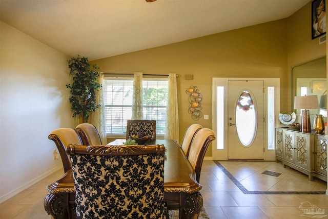 dining room featuring vaulted ceiling and light tile patterned floors