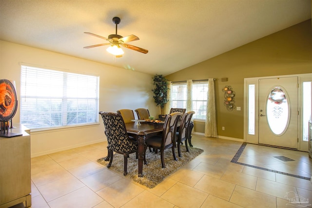 tiled dining space featuring vaulted ceiling and ceiling fan