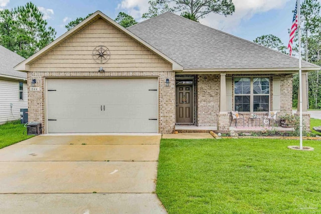 craftsman house featuring covered porch, central AC unit, a front yard, and a garage