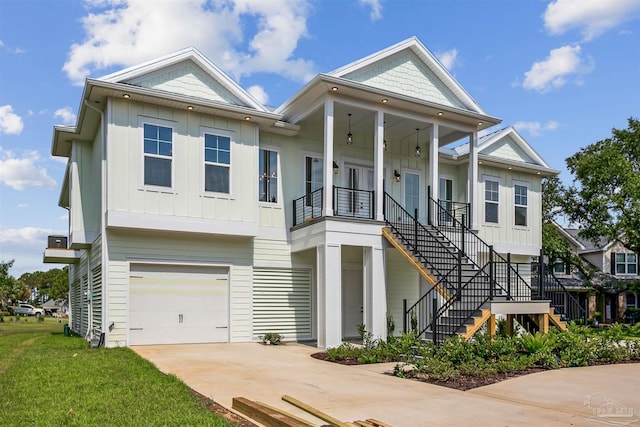 view of front facade with a porch, a garage, and a front yard