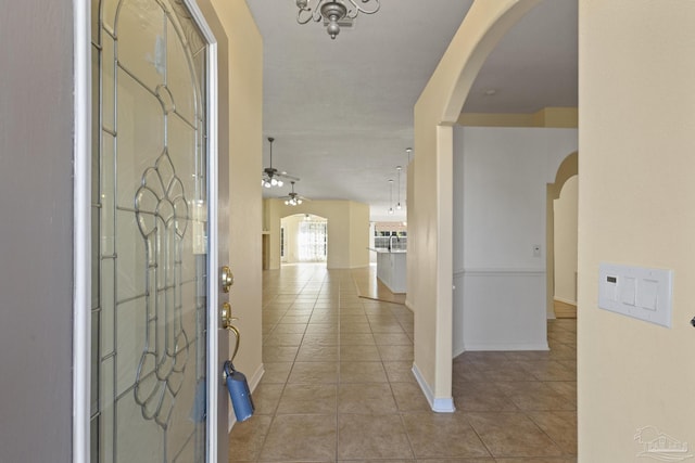 tiled entryway with ceiling fan