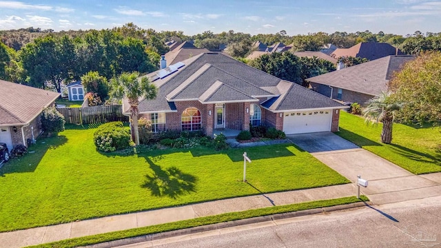 view of front of property with a front lawn and a garage