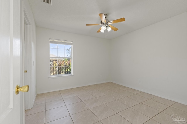 tiled empty room with ceiling fan