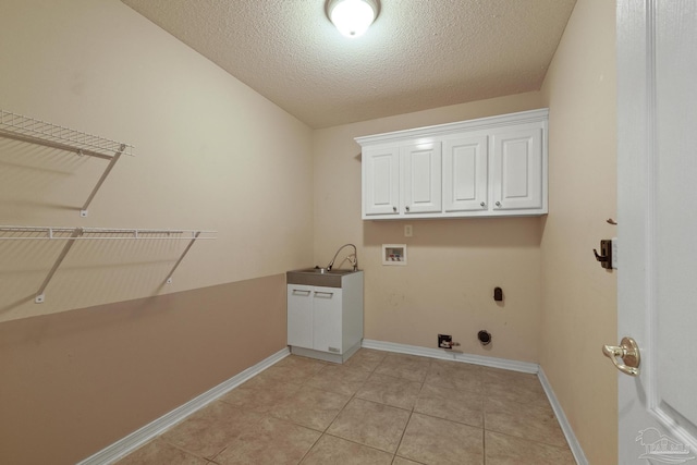 clothes washing area featuring cabinets, hookup for a gas dryer, sink, hookup for a washing machine, and a textured ceiling