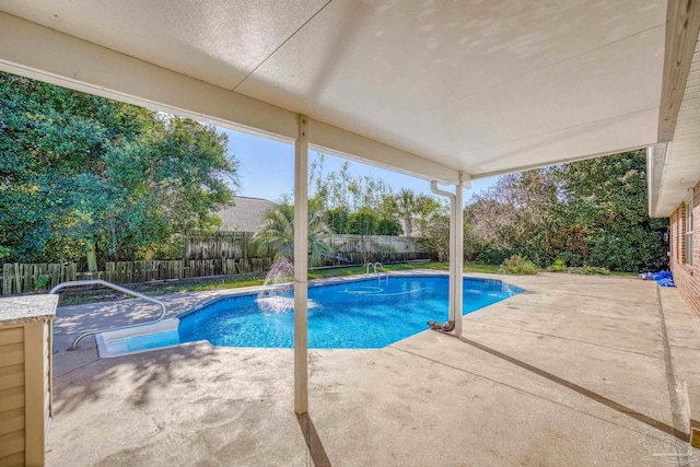 view of pool with a patio and pool water feature